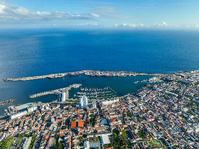 Drone view of Ponta Delgada city centre, marina and commercial harbour along the coast of São Miguel Island in the Azores.