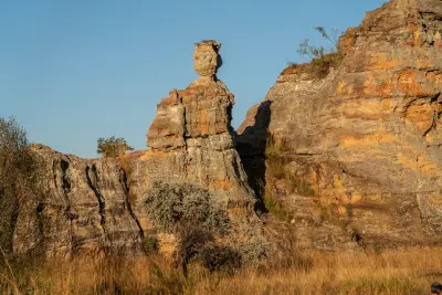 Lady Queen of Isalo sandstone pillar rising above dry grasslands in Isalo National Park, Madagascar