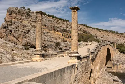 Ancient Roman Cendere Bridge with stone arches and monumental columns near Mount Nemrut, Turkey.