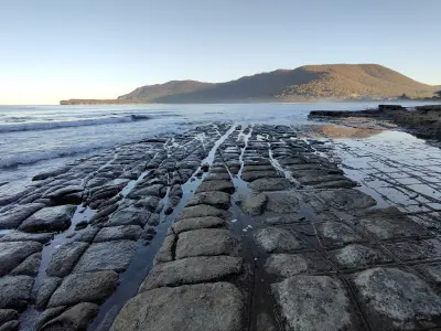 Pan and loaf rock formations across Tessellated Pavement at Pirates Bay on Tasmania’s Tasman Peninsula.