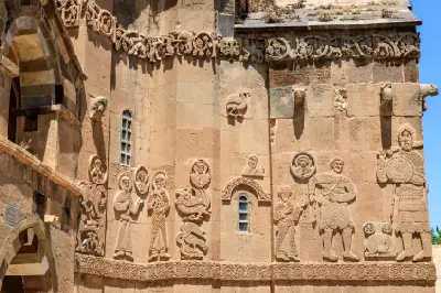 Carved stone reliefs depicting figures, animals and decorative motifs on the exterior of Holy Cross Church, Akdamar Island, Turkey.