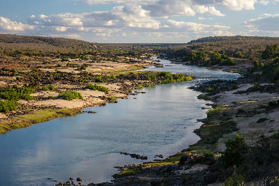 Elevated view of the Olifants River flowing through rocky wilderness in Kruger National Park, South Africa.