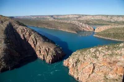 Aerial view of tidal water surging through the narrow gaps of Horizontal Falls between the rugged cliffs of the McLarty Range.