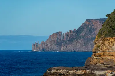 Columnar dolerite sea cliffs rising above the ocean at Cape Raoul, Tasmania.