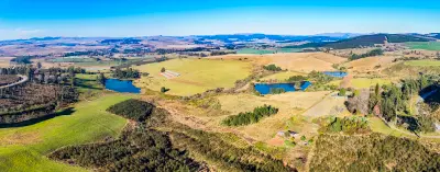 Aerial view of rolling farmland, plantations, farm dams and countryside in the KwaZulu-Natal Midlands.