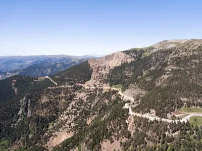Winding mountain road crossing rugged, pine-covered slopes high in the Zigana Mountains of northern Turkey.