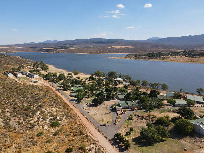 Aerial view of accommodation beside Clanwilliam Dam with semi-arid foothills and Cederberg mountain landscapes in the background, Western Cape, South Africa.