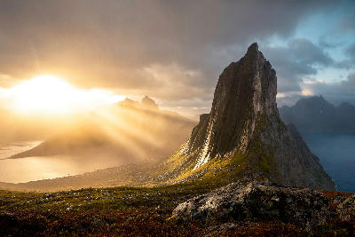 Segla mountain with dramatic sun rays over fjord landscape on Senja Island