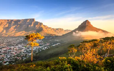 Golden sunset light on Lion’s Head and Table Mountain overlooking the city of Cape Town, South Africa.