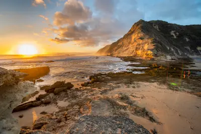 Golden sunset over the fossilised dune cliffs and rocky shoreline of Gericke's Point near Sedgefield on South Africa's Garden Route.