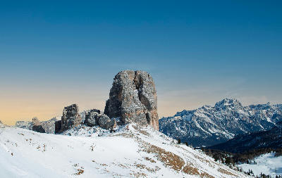 Cinque Torri rising from snow-covered alpine terrain near Cortina d’Ampezzo in the Dolomites, Italy.