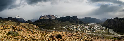 Panorama of El Chaltén town and valley seen from Mirador de los Cóndores with mountains partly covered by clouds, Patagonia, Argentina.