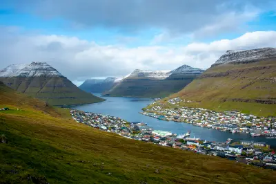 Harbour town of Klaksvík surrounded by layered basalt mountains on Borðoy in the Faroe Islands.