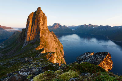 Segla mountain rising steeply above a fjord at sunset on Senja Island