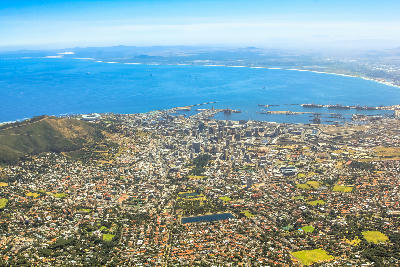 Aerial view of Cape Town City Bowl, with the harbour, V&A Waterfront, and Signal Hill bordering Table Bay in the Western Cape.