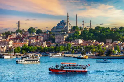 Ferries crossing the Bosphorus with Süleymaniye Mosque and Istanbul’s historic skyline in the background.
