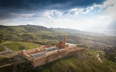 Aerial view of İshak Pasha Palace surrounded by rolling green mountains near Doğubayazıt in Eastern Anatolia, Turkey.