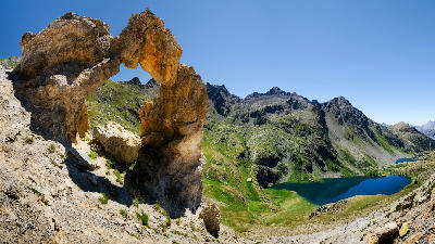 Rocky alpine landscape with limestone formations and mountain lake in Mercantour National Park, France