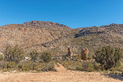 Trailhead and hiking path leading towards the Maltese Cross area in the Cederberg Mountains, surrounded by rugged sandstone slopes and fynbos vegetation.