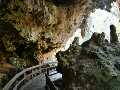 Timber walkway passing through the limestone entrance of Mammoth Cave in Leeuwin-Naturaliste National Park, Western Australia.