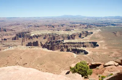 Elevated view from Grand View Point showing White Rim plateau, layered canyon walls, and desert terrain in Canyonlands National Park Utah