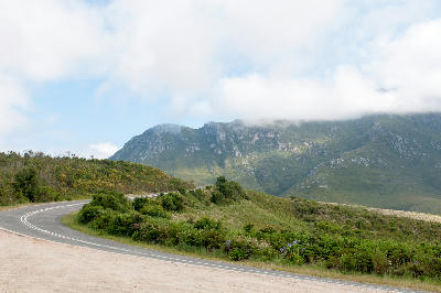 Robinson Pass winding through fynbos-covered slopes beneath low cloud in the Outeniqua Mountains of South Africa.