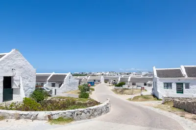 Whitewashed fishermen’s cottages and quiet village streets in Arniston near Cape Agulhas in the Western Cape, South Africa.