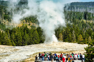 Old Faithful geyser eruption crowd Yellowstone National Park Wyoming tourists boardwalk steam plume