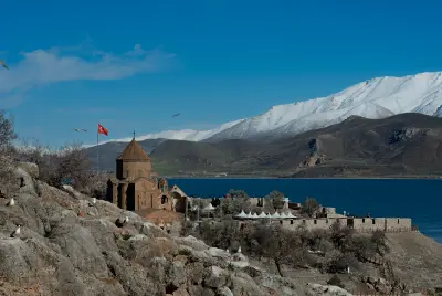 Holy Cross Church on Akdamar Island beside Lake Van, with snow-capped Mount Artos in the background, eastern Turkey.