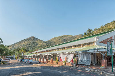 Historic street and commercial buildings in Barberton with the Makhonjwa Mountains in the background, Mpumalanga, South Africa.