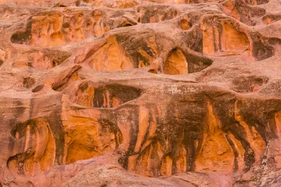 Intricately eroded red sandstone covered with cavities and sculpted hollows along Long Canyon on the Burr Trail.