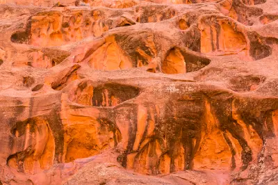 Intricately eroded red sandstone covered with cavities and sculpted hollows along Long Canyon on the Burr Trail.