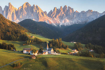 Village of Villnöss with the Church of St. Magdalena in Val di Funes, set against the Dolomites, South Tyrol, Italy.