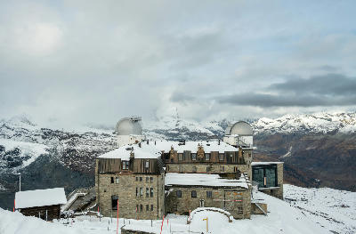Kulmhotel Gornergrat covered in fresh snow with observatory domes on the Gornergrat ridge near Zermatt, Switzerland.