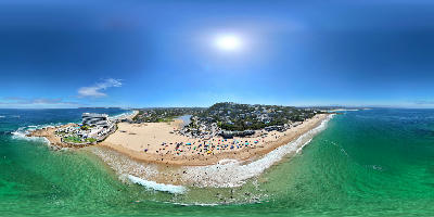 Aerial view of Central Beach in Plettenberg Bay showing Beacon Isle, sandy shoreline, turquoise ocean and the surrounding coastal town.