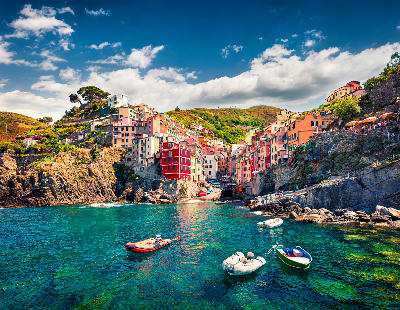 Morning view of Riomaggiore, the first village of Cinque Terre, with colourful houses above the Mediterranean Sea in Liguria, Italy.