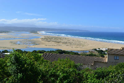 Elevated view of Lookout Beach and the Keurbooms Estuary in Plettenberg Bay, showing expansive sandbanks, tidal channels and the Indian Ocean coastline.