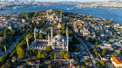 Aerial view of Sultanahmet in Istanbul showing the Blue Mosque, Hagia Sophia, surrounding historic district and the Bosphorus.