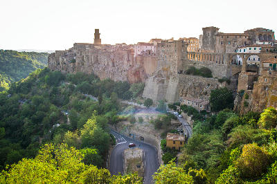 View of the cliff-top town of Pitigliano above the valley road in Grosseto province, Tuscany, Italy.