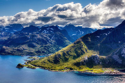 View from Offersøykammen on Vestvågøya in the Lofoten Islands, looking toward the coastal village of Napp on Flakstadøya with fjord waters and rugged mountains in Norway.