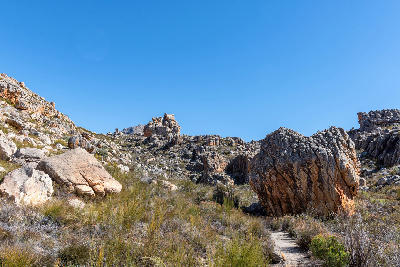 Rock formations and rugged mountain terrain along the Bokveldskloof hiking trail leading to Maltese Cross in the Cederberg Wilderness, Western Cape, South Africa.