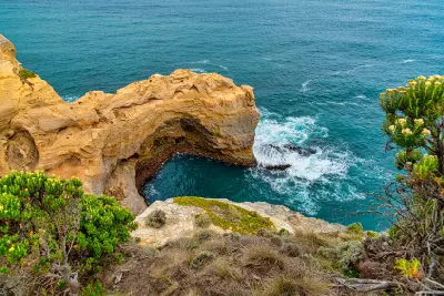 The Arch viewed from above with turquoise water and waves along Victoria’s Great Ocean Road.
