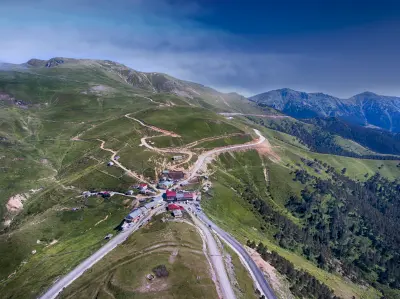 Aerial view of Zigana Pass with winding roads crossing green mountain slopes in the Zigana Mountains, Turkey.