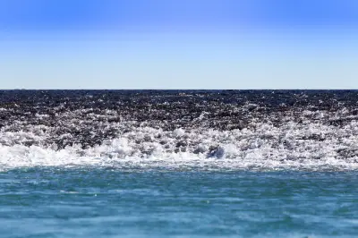 Seawater cascades over the exposed edge of Montgomery Reef as the falling tide drains from the reef.