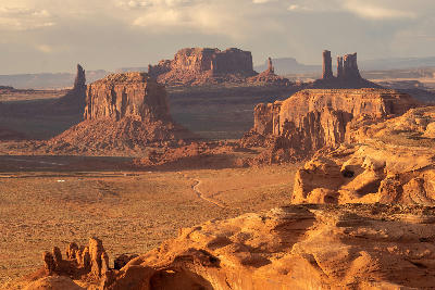 Monument Valley at sunrise from Hunts Mesa with large mesas and buttes across desert landscape on Arizona Utah border