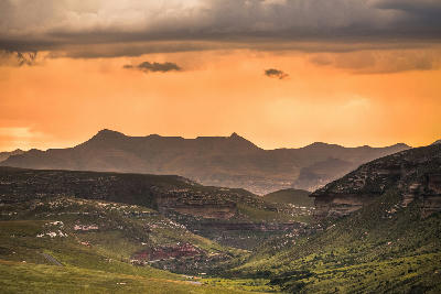 Sunset storm clouds over the mountain valleys and sandstone highlands of the Golden Gate and Maluti Foothills region in South Africa.