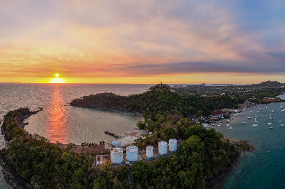 Sunset aerial view over volcanic coastline and harbor on Nosy Be Island in Madagascar