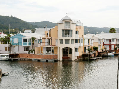 Canal-front homes with private docks on Thesen Island in Knysna Lagoon, South Africa.