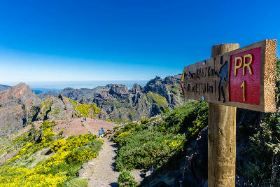 PR1 Vereda do Areeiro trail sign and mountain path leading from Pico do Areeiro toward Pico Ruivo, Madeira, Portugal.