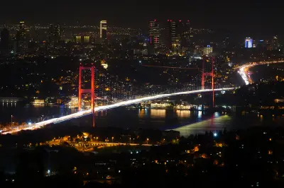 Illuminated 15 July Martyrs Bridge spanning the Bosphorus at night in Istanbul.